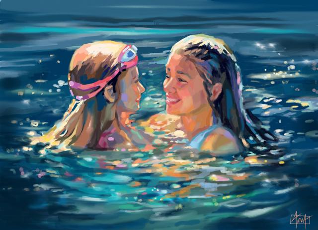 Two children playing together in the water