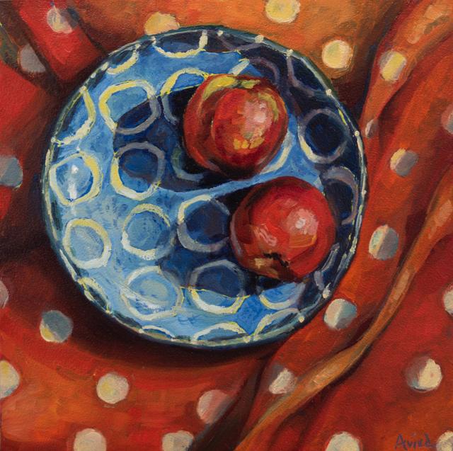 Still life of apples on a patterned plate