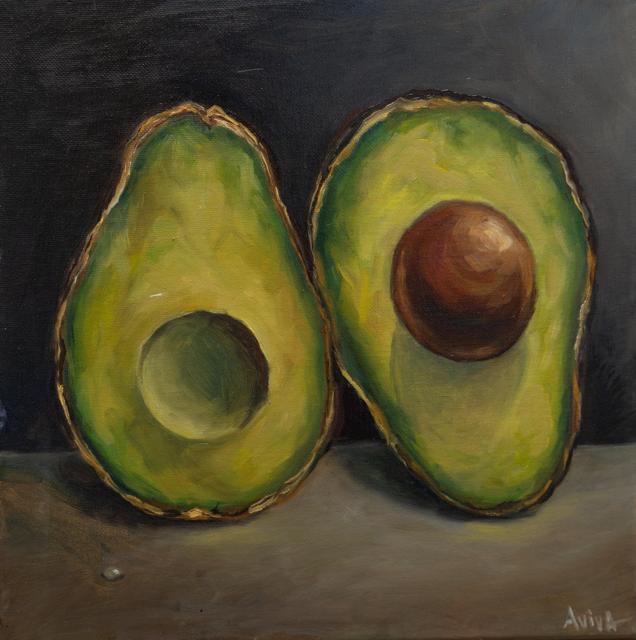 Still life of two halved avocados