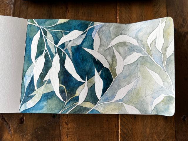 Watercolor sketchbook spread of leaves
