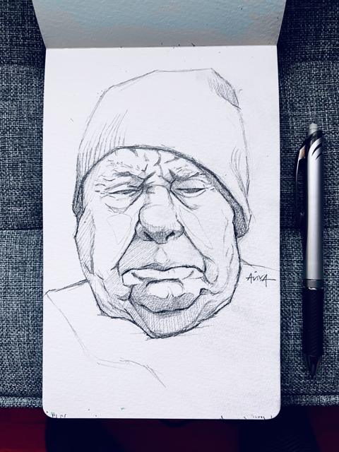 Pencil sketch of an older man in a beanie, in the sketchbook