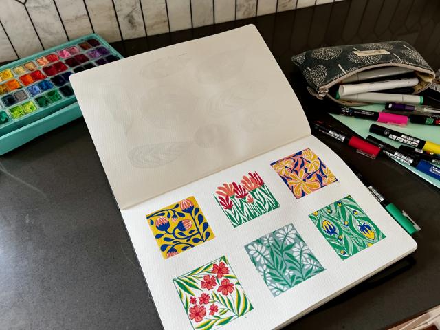Sketchbook page of small painted pattern studies