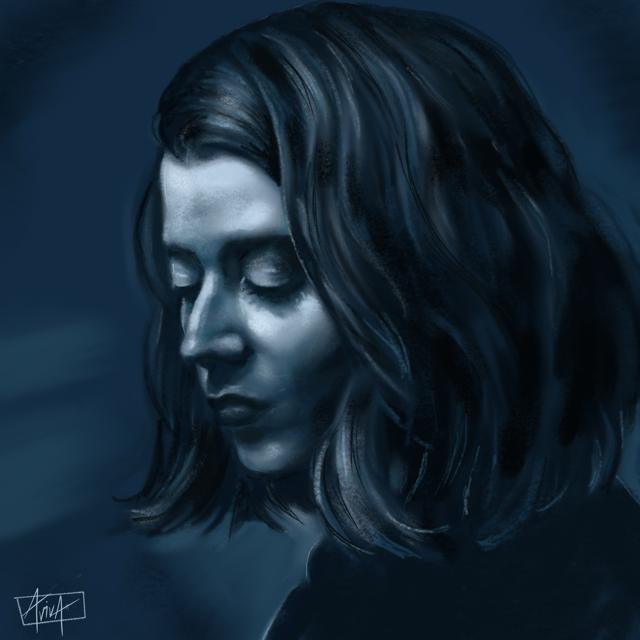 Monochromatic blue portrait of a woman looking down