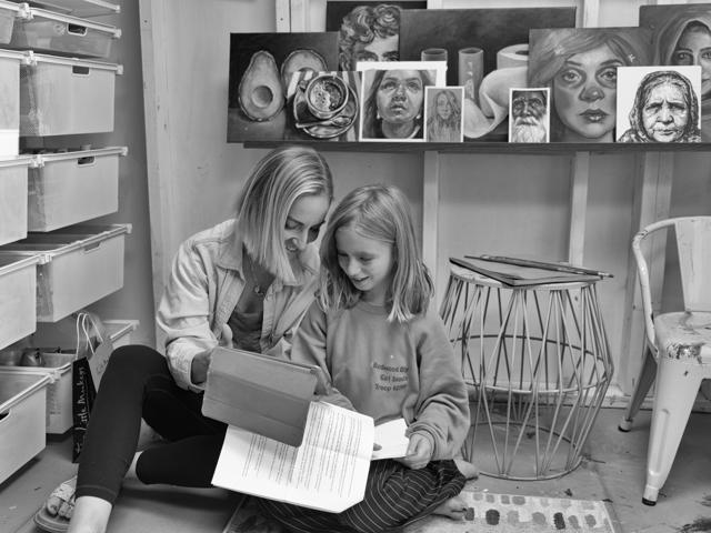 Black and white photo: reading together in the studio