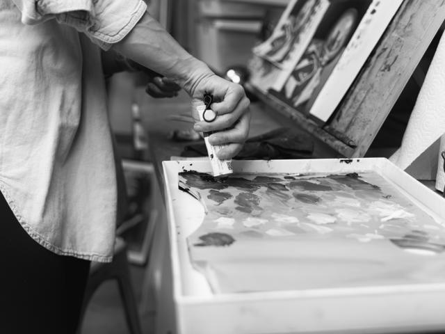 Black and white photo: squeezing paint onto the palette tray