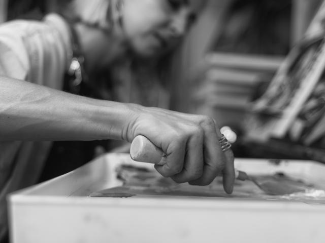 Black and white photo: blending paint with a palette knife