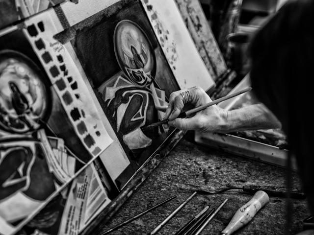 Black and white photo: painting fine detail with a brush