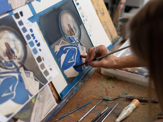 Color photo: painting fine detail with a brush