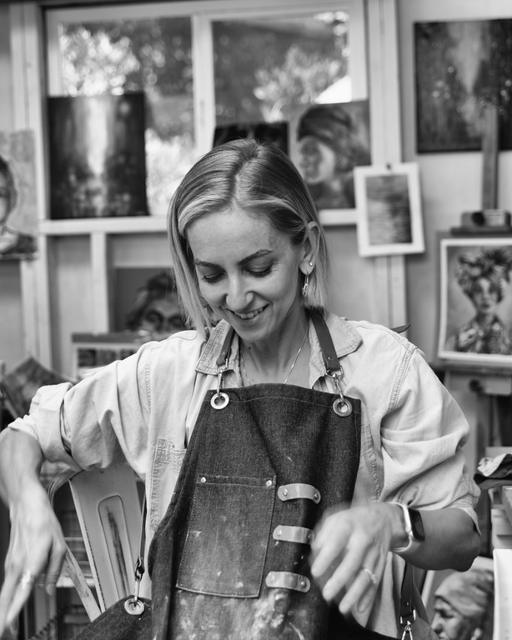 Black and white photograph of the artist at the easel